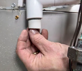 Cleaning burrs off the cut end of the PVC pipe