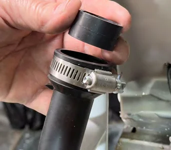 Removing the bushing from the end of the flexible condensate trap